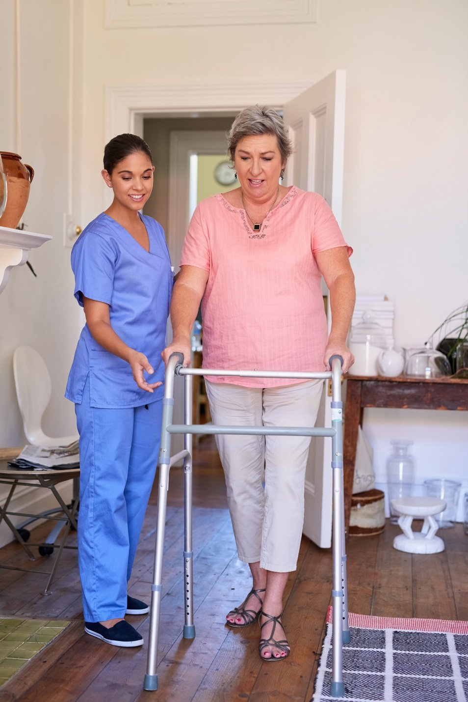 Senior Woman, Nurse and Support in Walking Frame for Homecare, Healthcare or Muscle Rehabilitation. Caregiver, Elderly Patient or Real People with Disability, Parkinson and Helping for Home Nursing