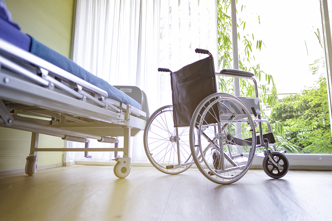 wheel chair and the Patient's bed in the hospital, Empty wheelchair and Patient's bed standing in hospital with sunlight background.